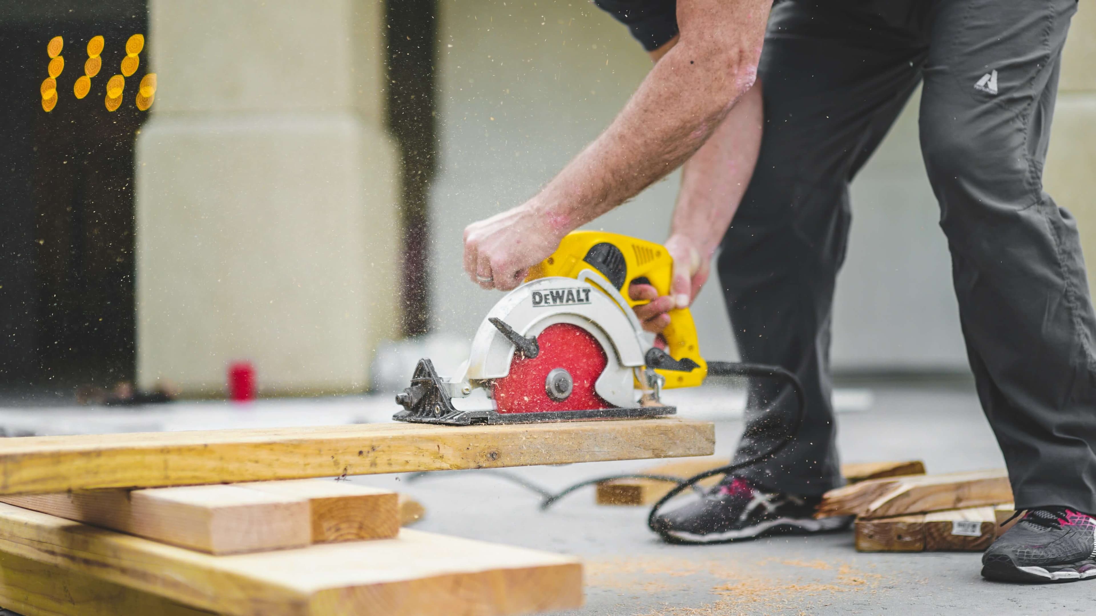 Stock Construction Image https://unsplash.com/photos/man-in-black-sweatpants-using-dewalt-circular-saw-and-cutting-a-wood-plank-A1g0oeX29ec